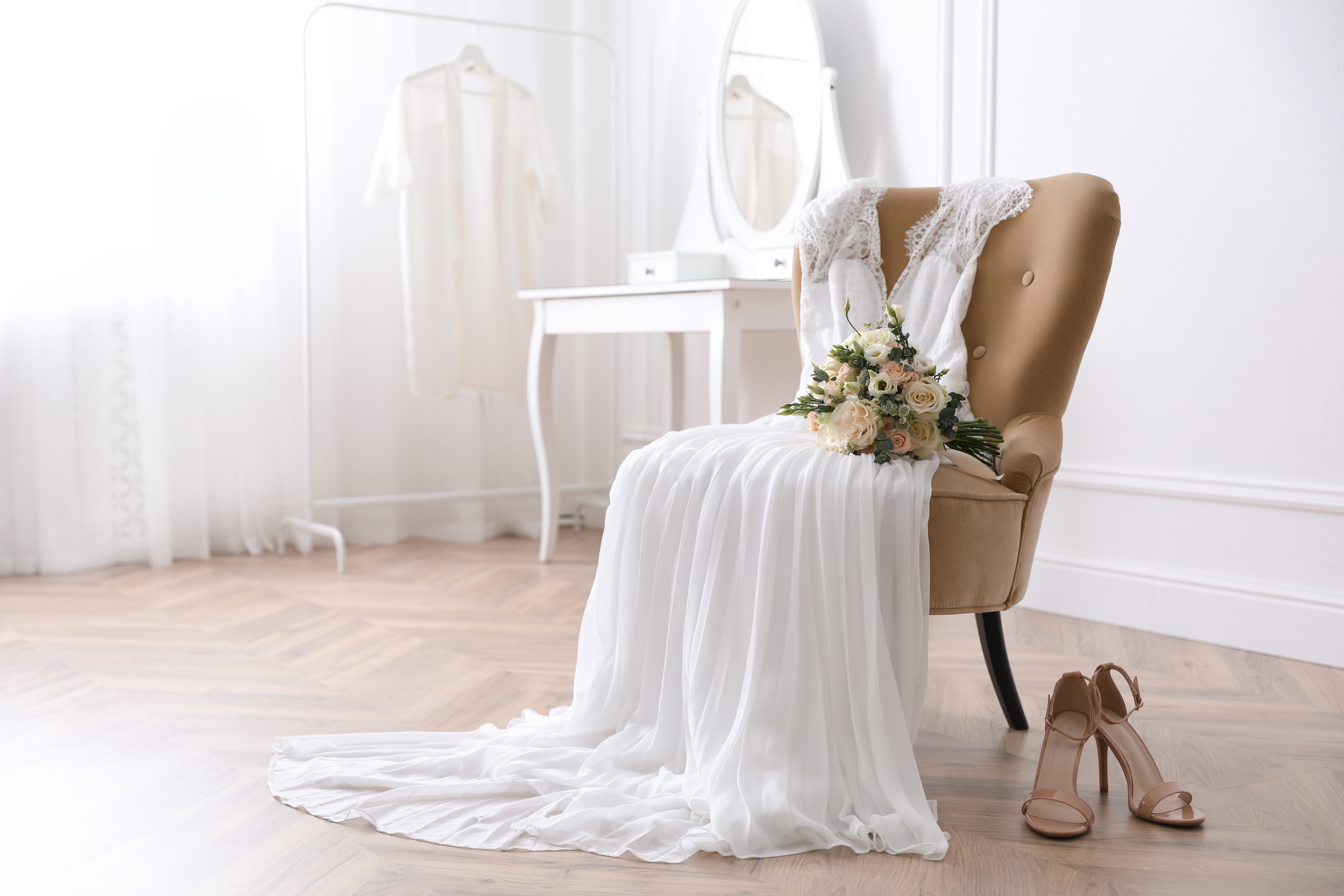 Bridal dress draped on a chair